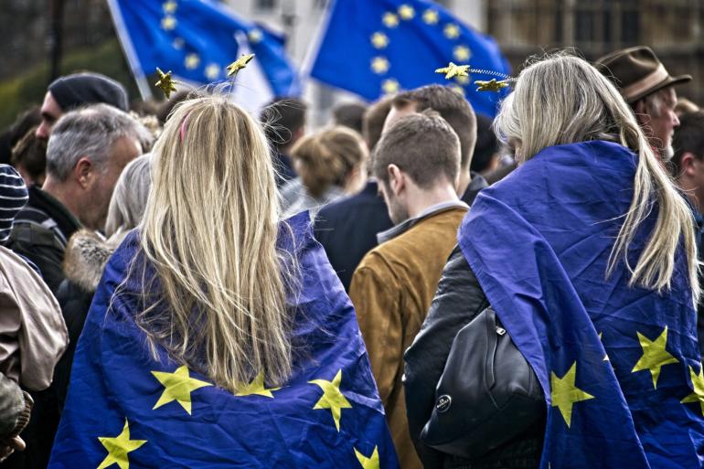 Manifestanti con bandiere UE